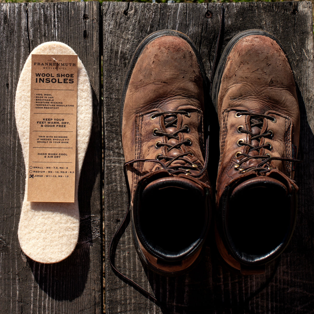 Wool shoe inserts beside brown leather boots